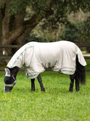 Side view of a dark colored horse wearing the stone LeMieux Arika Armour-Tek Fly Blanket while grazing in a field