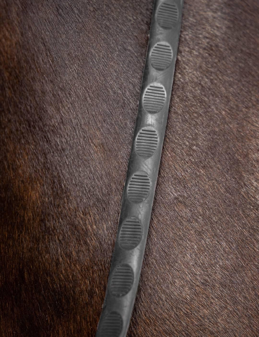 Close-up of black LeMieux Magna Grip Rubber Reins on a horse’s neck showing textured grip