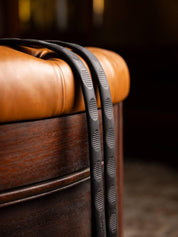 Brown LeMieux Magna Grip Rubber Reins draped over an ottoman