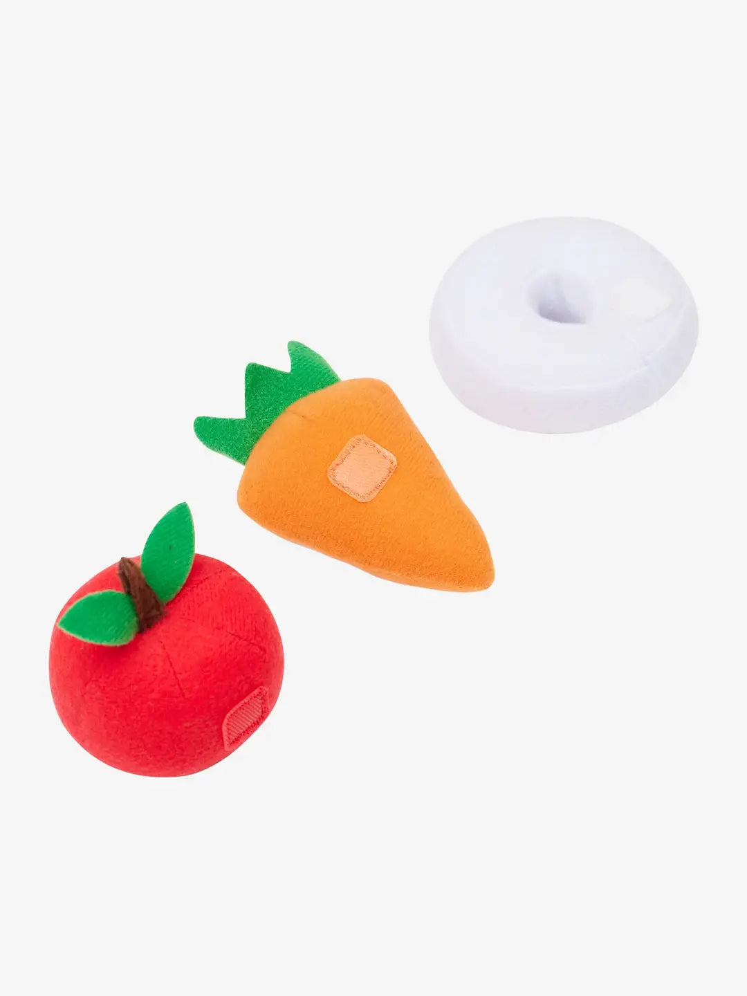Back view of a stuffed carrot, apple, and peppermint with velcro on a white background