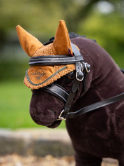 Close-up angled front view of a dark colored toy pony wearing the ginger LeMieux Toy Pony Fly Hood