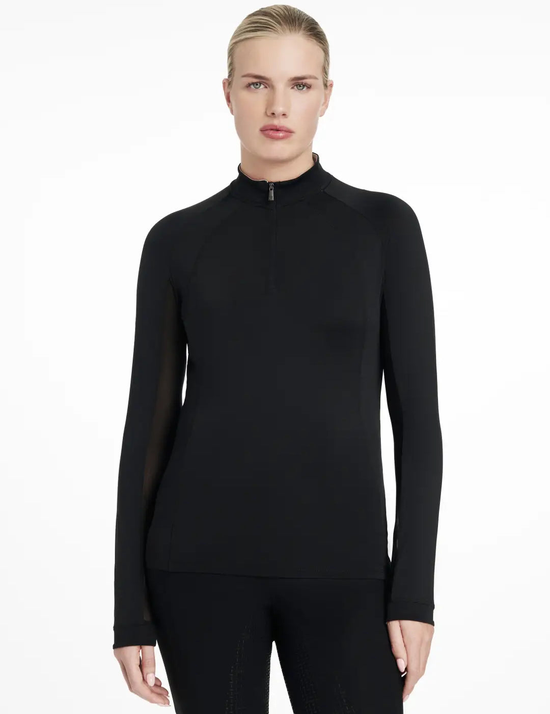 Front view of a model wearing the black LeMieux Halle Lightweight Base Layer on a white background