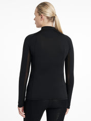 Back view of a model wearing the black LeMieux Halle Lightweight Base Layer on a white background
