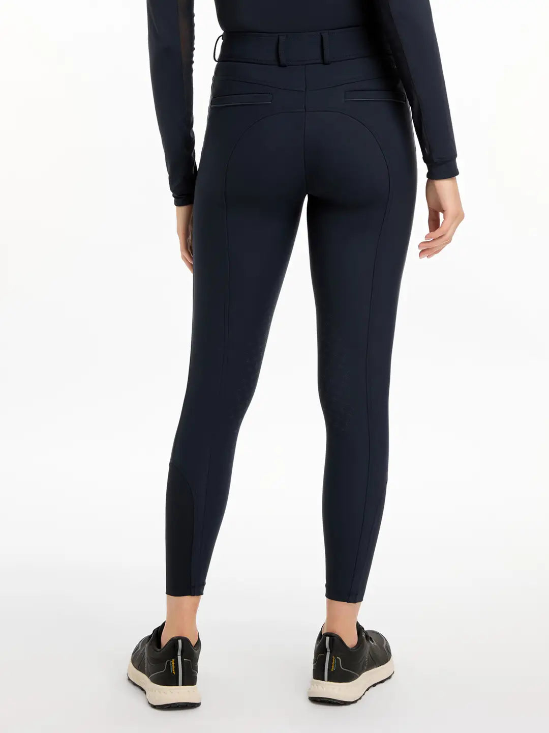 Back view of a model wearing the navy LeMieux Isabelle Knee Grip Breeches on a white background
