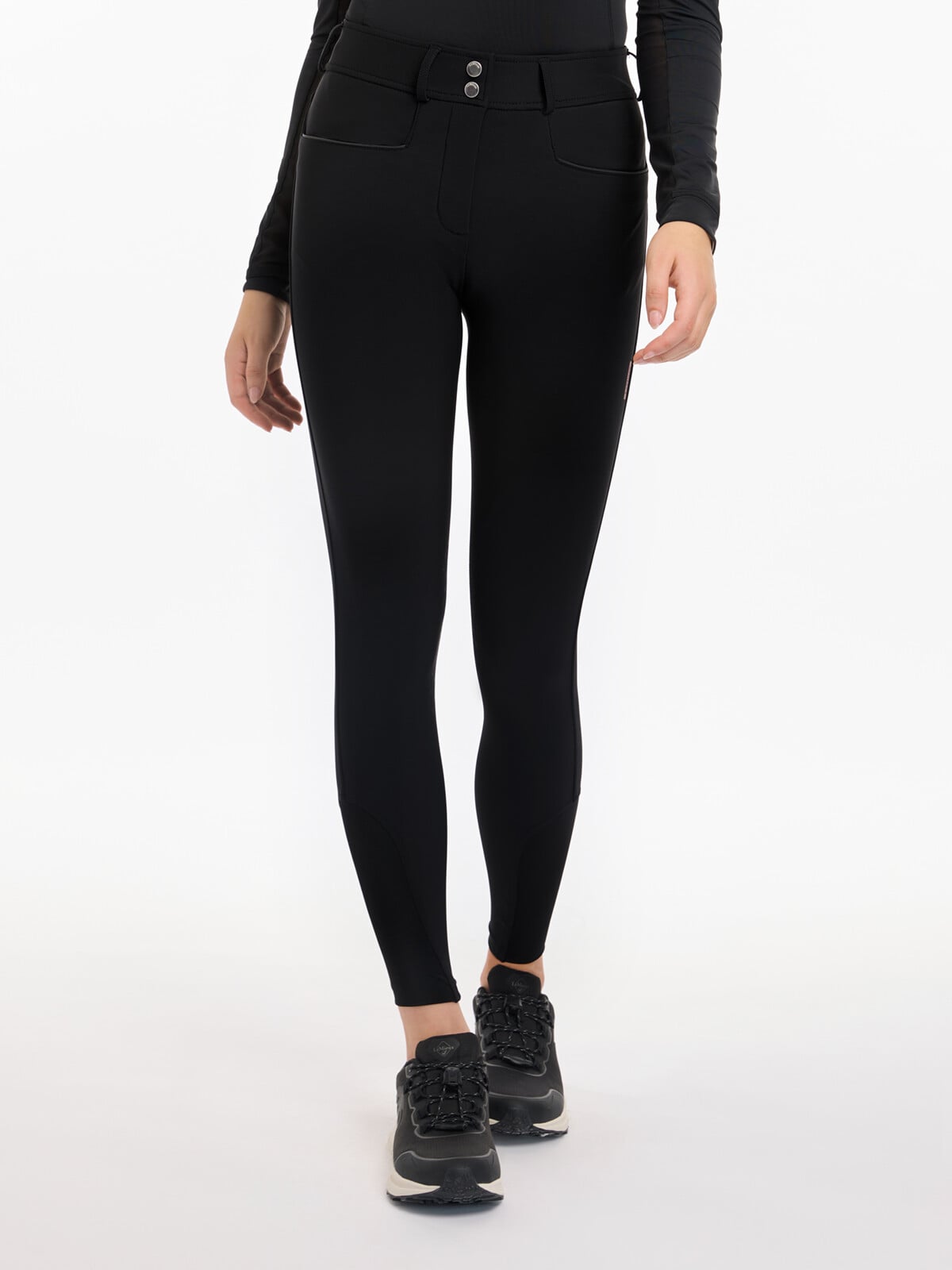 Front view of a model wearing the black LeMieux Isabelle Knee Grip Breeches on a white background