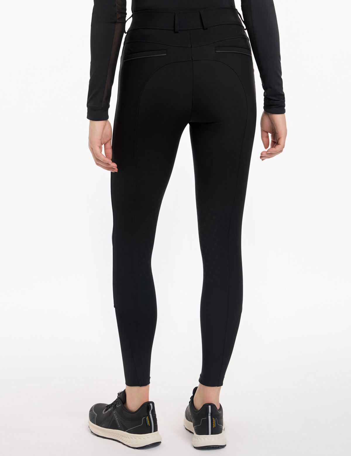 Back view of a model wearing the black LeMieux Isabelle Knee Grip Breeches on a white background