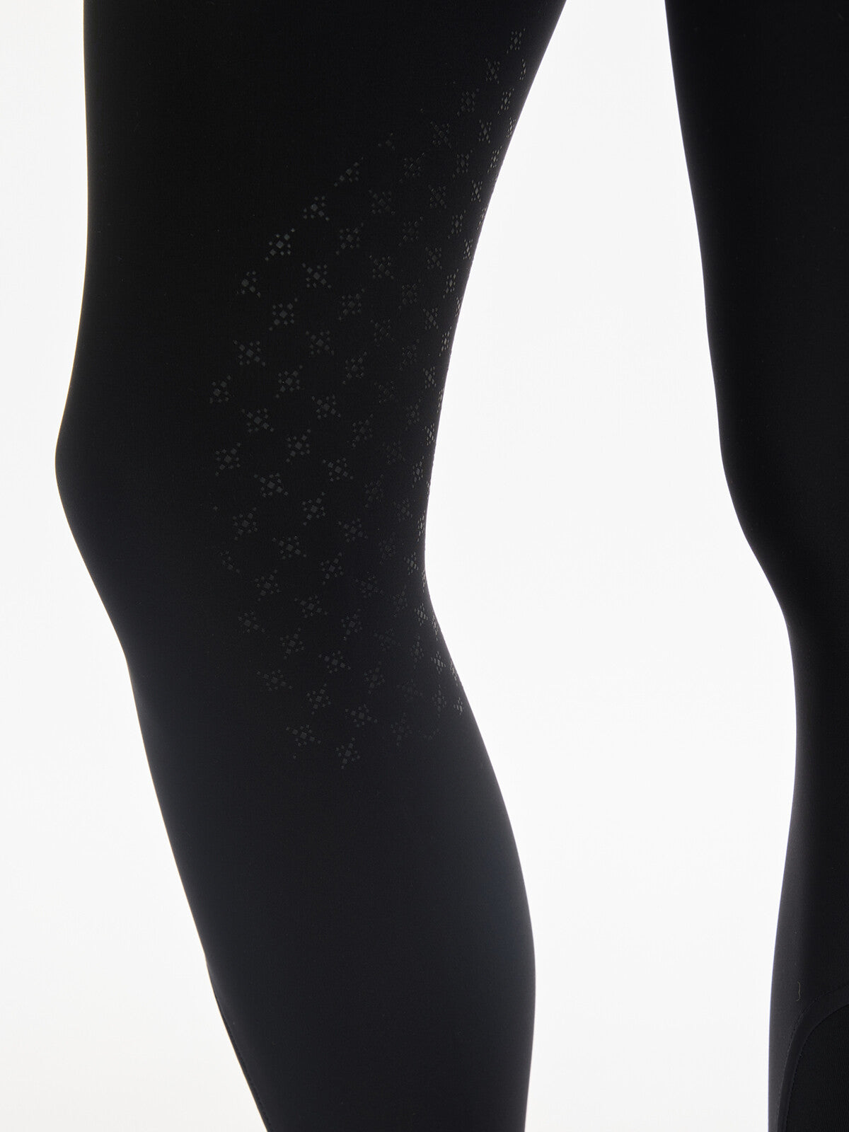 Close-up view of the silicone knee grip on the black LeMieux Isabelle Knee Grip Breeches on a white background