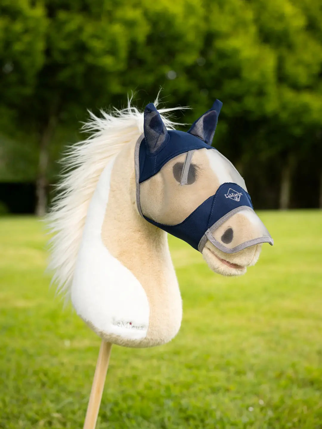 LeMieux Hobby Horse Fly Mask in navy on a hobby horse outside