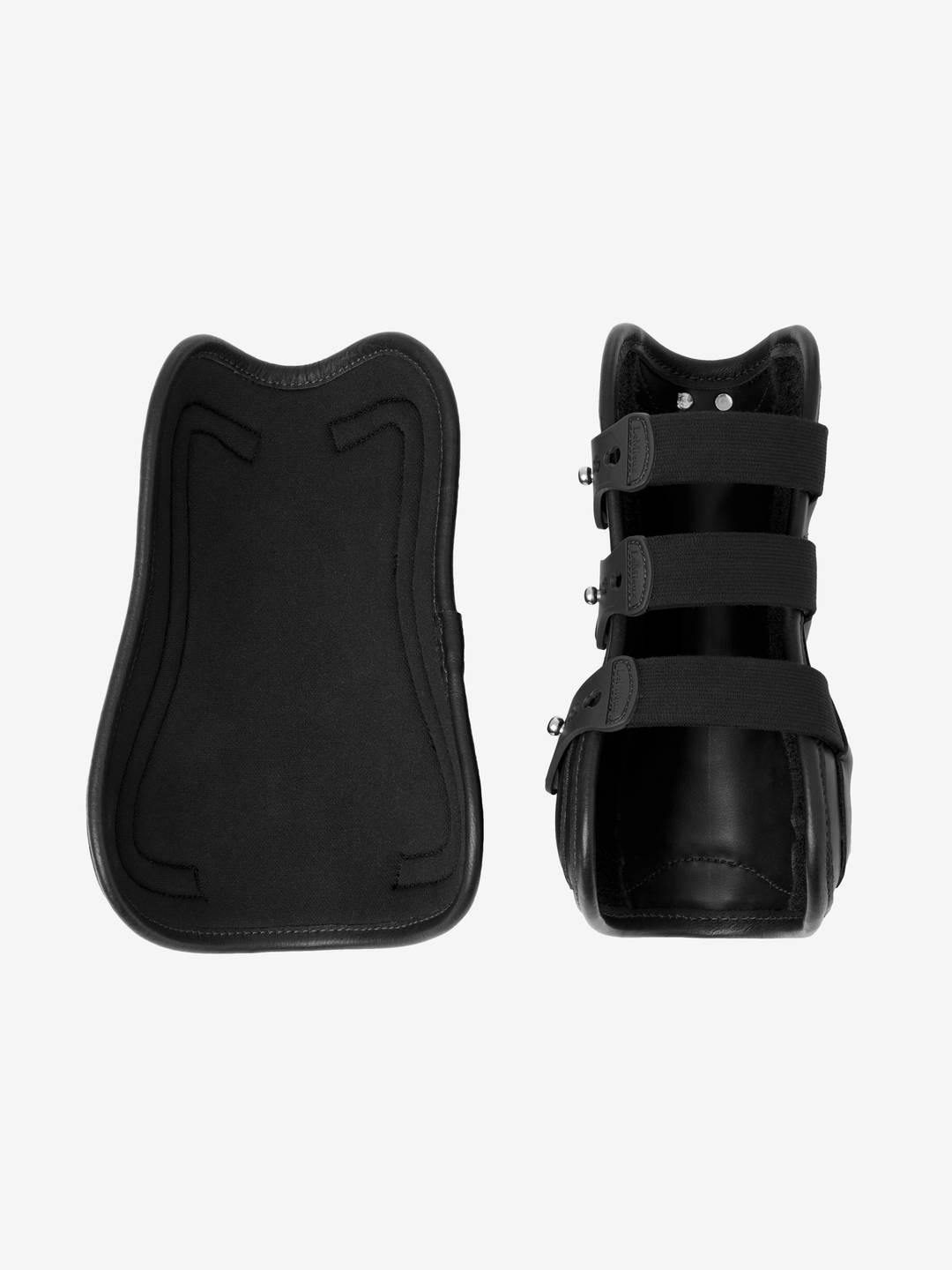 View of 2 black LeMieux Capella 3 Strap Tendon Boots side by side - one showing the strap closed and the other showing the interior of the boot on a white background
