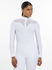 Front view of a female model wearing the white LeMieux Emily Long Sleeve Show Shirt on a plain background