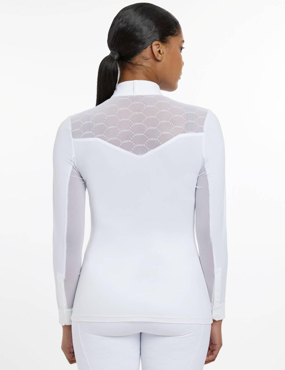 Back view of a female model wearing the white LeMieux Emily Long Sleeve Show Shirt on a plain background