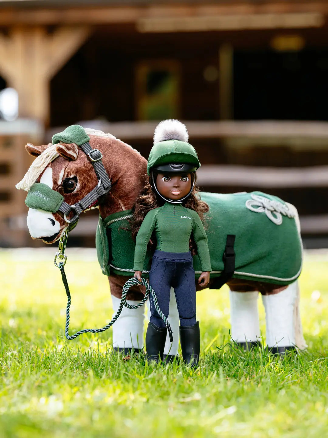 Front view of the green Maya LeMieux Toy Rider standing outside in front a toy pony