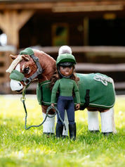 Front view of the green Maya LeMieux Toy Rider standing outside in front a toy pony