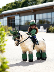 Angled front view of the green Maya LeMieux Toy Rider riding a buckskin toy pony outside