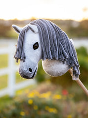 Side view of the Earl Grey LeMieux Hobby Horse outside