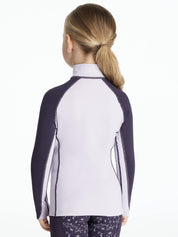 Back view of a young female model wearing the purple LeMieux Mini Long Sleeve Baselayer on a white background