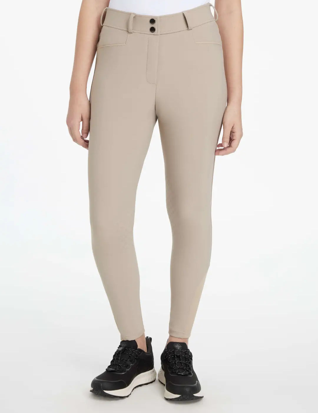 Front view of a model wearing the tan LeMieux Isabelle Knee Grip Breeches on a white background