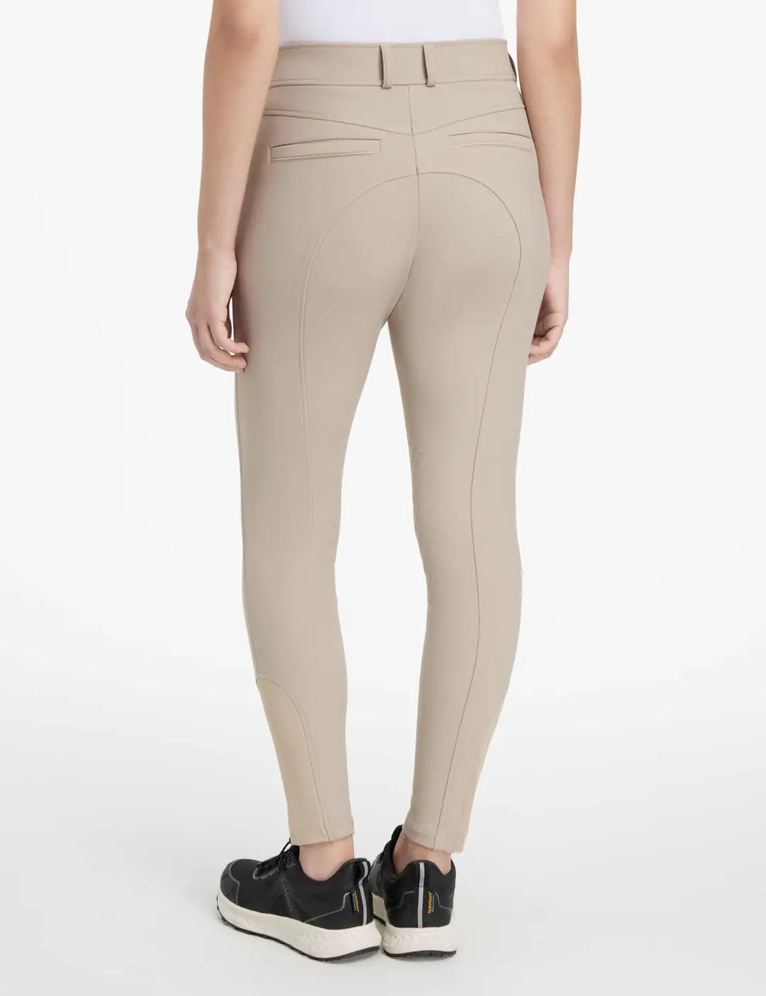 Back view of a model wearing the tan LeMieux Isabelle Knee Grip Breeches on a white background