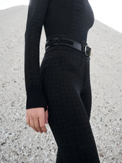 Side view of a model wearing the LeMieux Aspen Houndstooth Gigi Bregging in front of a rocky background