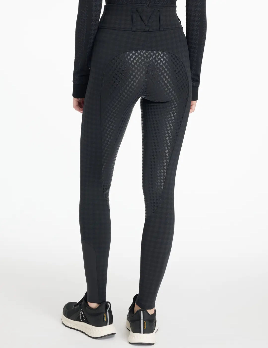 Back view of a model wearing the LeMieux Aspen Houndstooth Gigi Bregging on a plain background