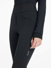 Angled front view of a model wearing the LeMieux Aspen Houndstooth Gigi Bregging on a plain background