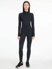 Full body front view of a model wearing the LeMieux Aspen Houndstooth Gigi Bregging, matching top, and black tennis shoes on a plain background