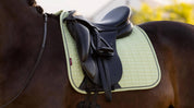 Close-up side view of a horse wearing the macaron LeMieux Suede Dressage Square Pad