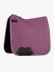 Side view of the mallow LeMieux Suede Dressage Square Pad on a white background