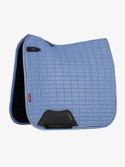 Side view of the powder blue LeMieux Suede Dressage Square Pad on a white background