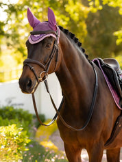 Horse standing outside wearing the LeMieux Loire Fly Hood in Mallow