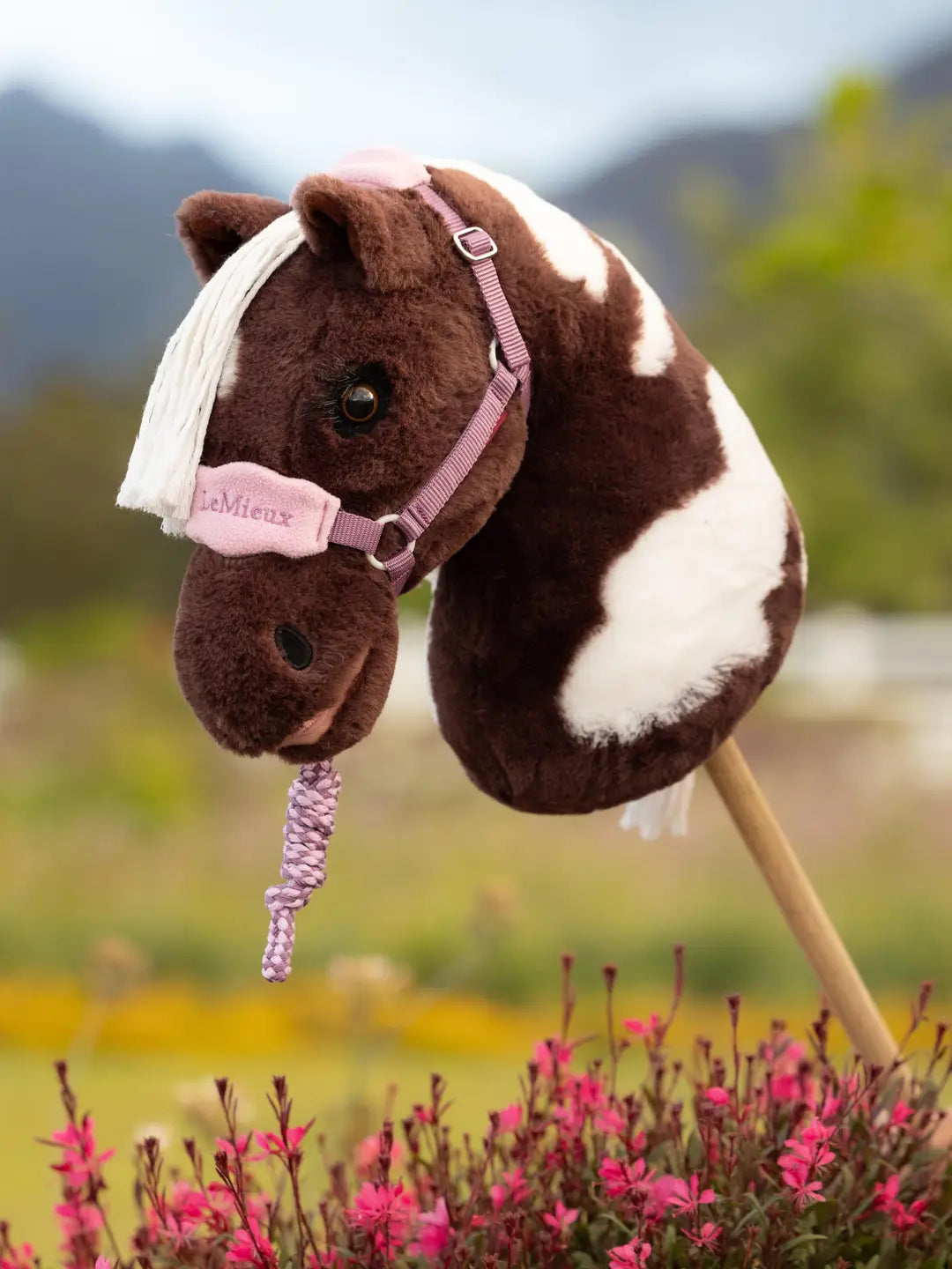 LeMieux Hobby Horse Vogue Headcollar & Leadrope in pink on a hobby horse outside
