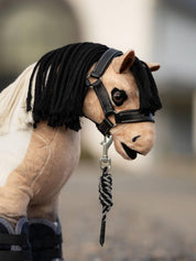 Side view of a buckskin paint toy pony wearing the black LeMieux Toy Pony Leather Headcollar & Leadrope