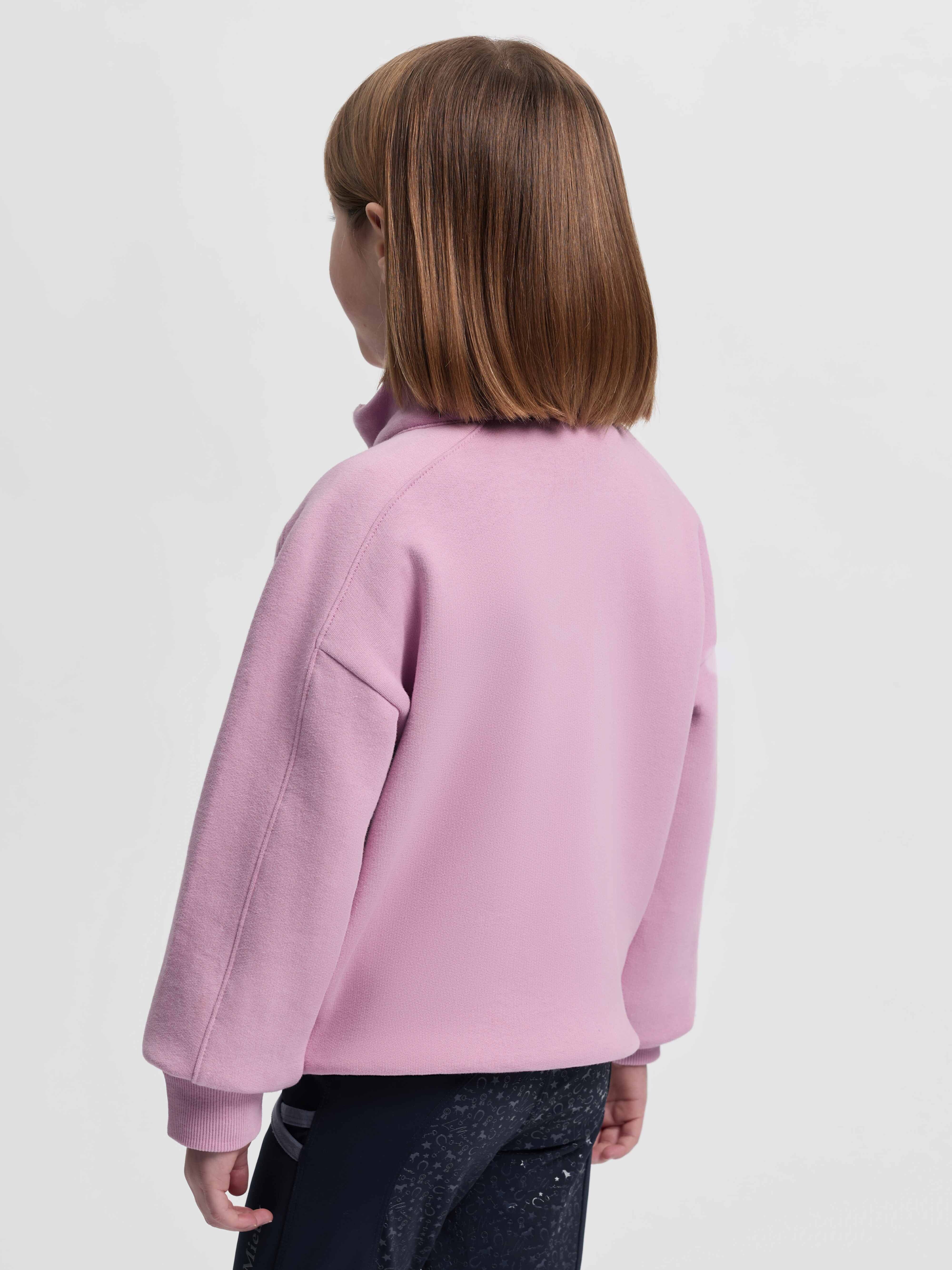 Back view of child model wearing a LeMieux Mini Quinn Quarter Zip Sweatshirt in a pink color
