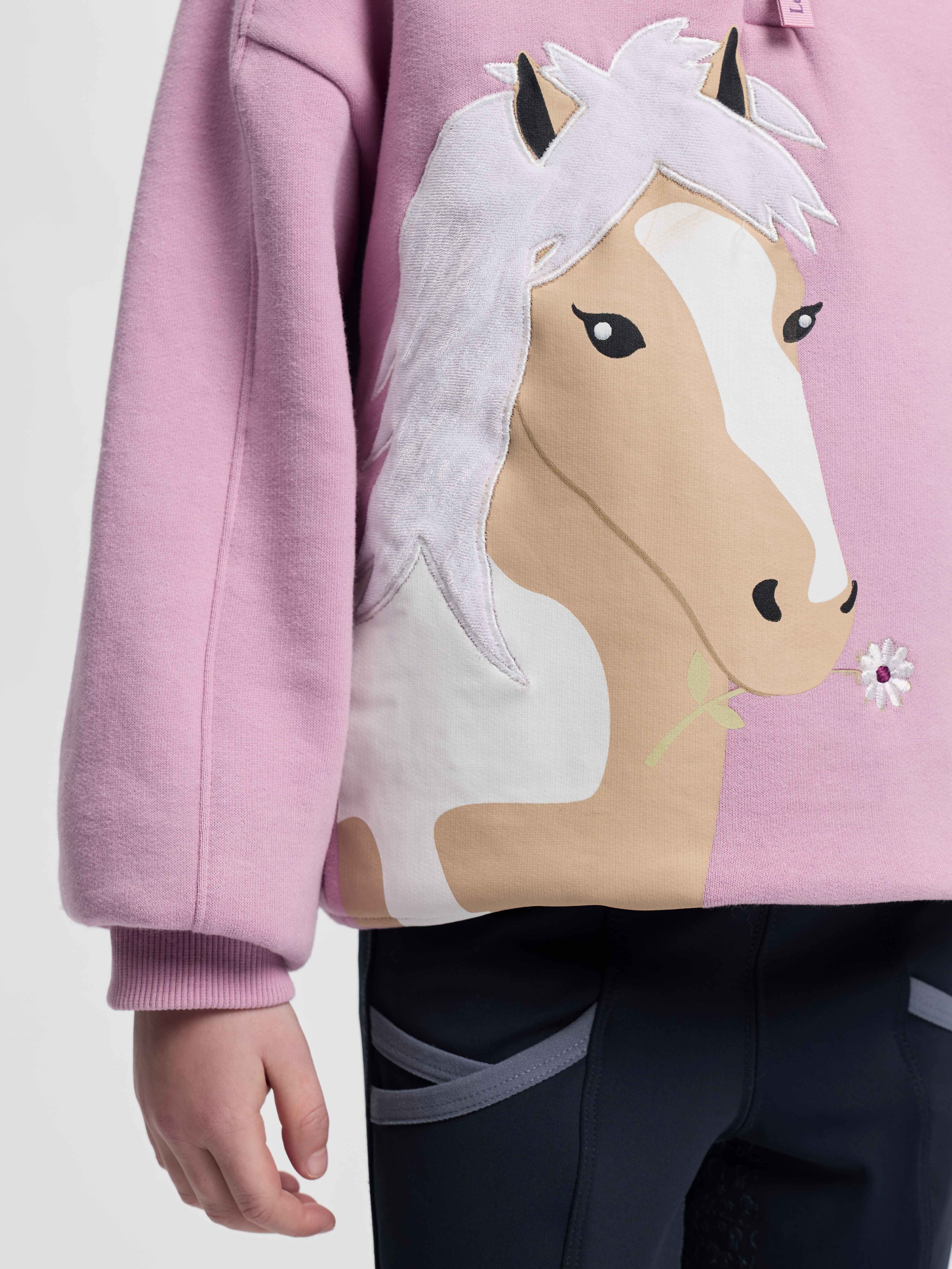Close up of the horse head detail on the LeMieux Mini Quinn Quarter Zip Sweatshirt in a pink color
