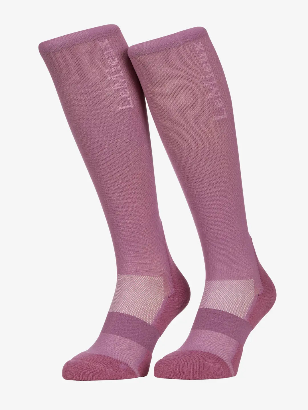 Angled front view of a pink pair of LeMieux Performance Socks on a white background