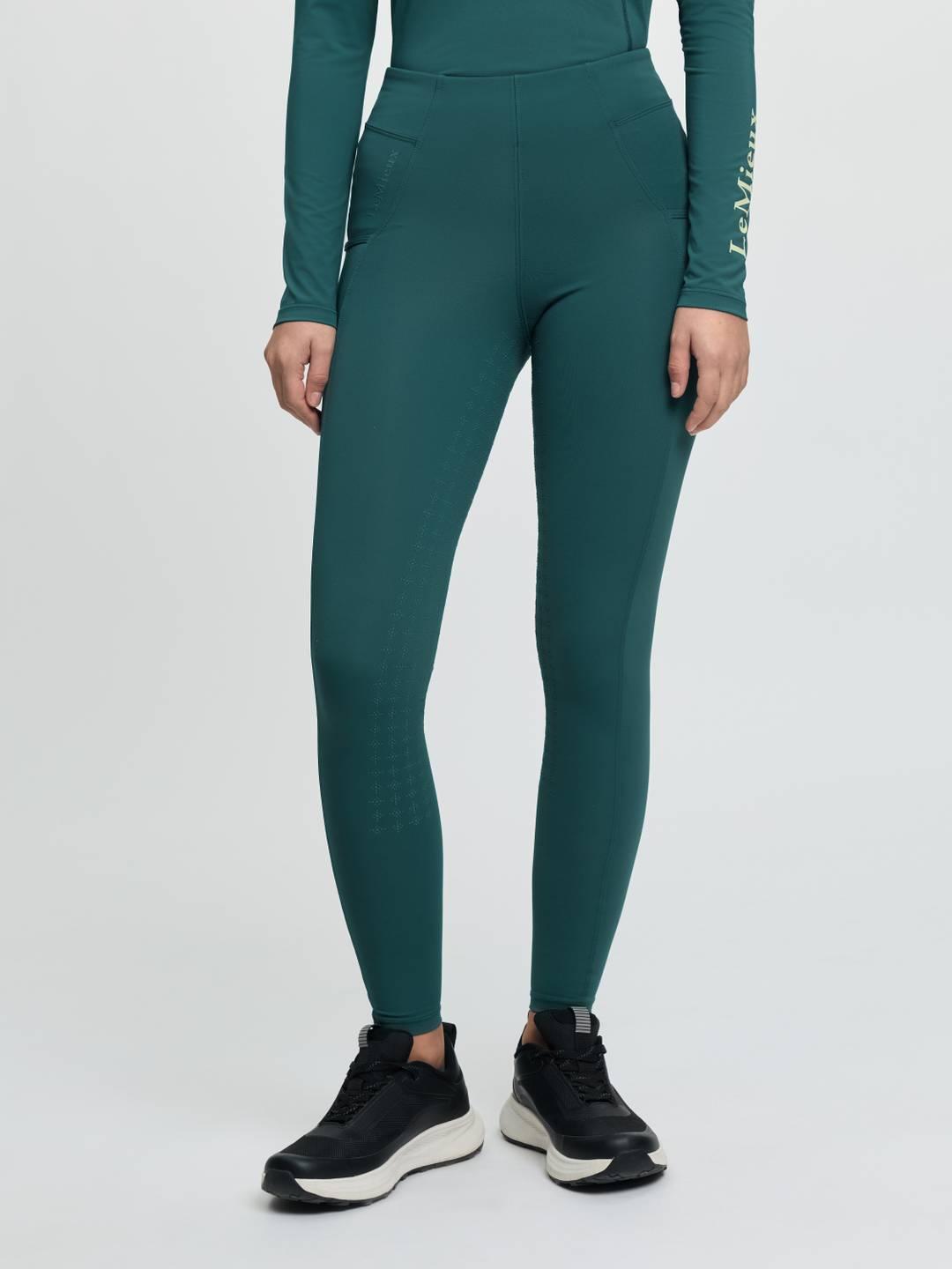Front view of a model wearing the jungle Lemieux Young Rider Orla Pull On Tight on a plain background
