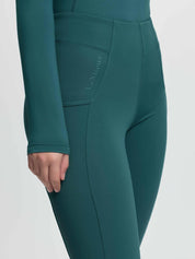 Angled front view of a model wearing the jungle Lemieux Young Rider Orla Pull On Tight on a plain background