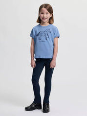 Full body front view of a young female model wearing the powder blue LeMieux Mini Alex T-Shirt on a plain background
