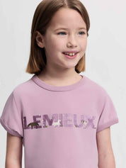 Close-up front view of a young female model wearing the fondant LeMieux Mini Alex T-Shirt on a plain background