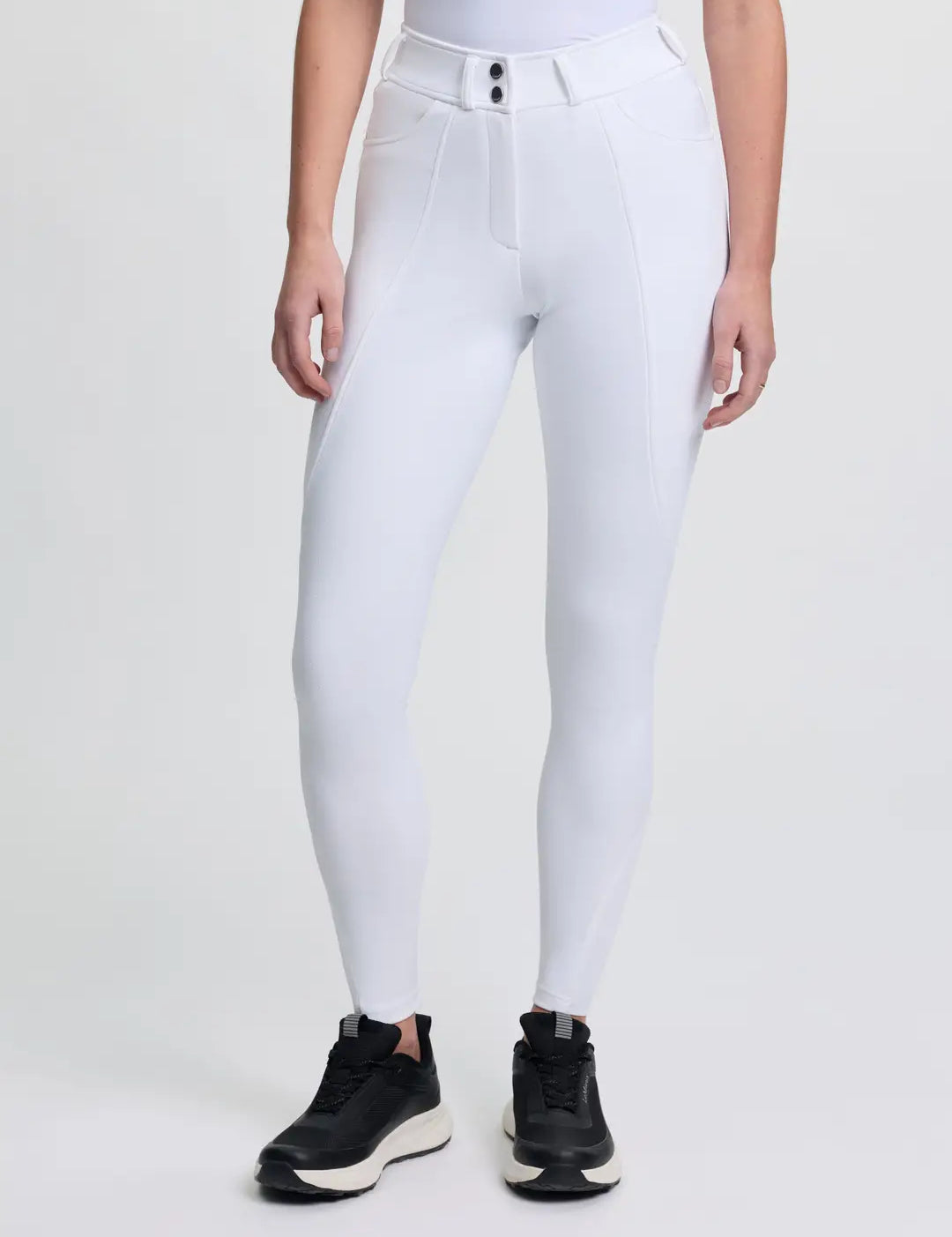Front view of a model wearing the white LeMieux Brilliance Full Seat Breeches on a plain background