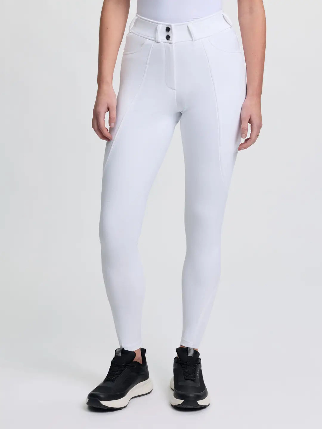 Front view of a model wearing the white LeMieux Brilliance Full Seat Breeches on a plain background