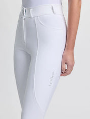 Angled front view of a model wearing the white LeMieux Brilliance Full Seat Breeches on a plain background