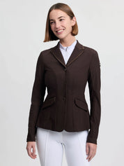 Front view of a female model wearing the brown LeMieux Brilliance Diana Show Jacket on a plain background