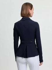 Back view of a female model wearing the navy LeMieux Brilliance Diana Show Jacket on a plain background