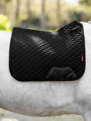 Side view of a gray horse wearing the black LeMieux Brilliance Dressage Square