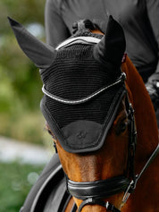 Close-up front view of a bay horse wearing the black LeMieux Brilliance Fly Hood