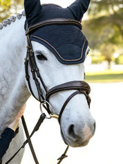 Close-up front view of a gray horse wearing the navy LeMieux Brilliance Fly Hood