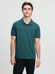 LeMieux Men’s Classique polo shirt in green, front view worn with black pants
