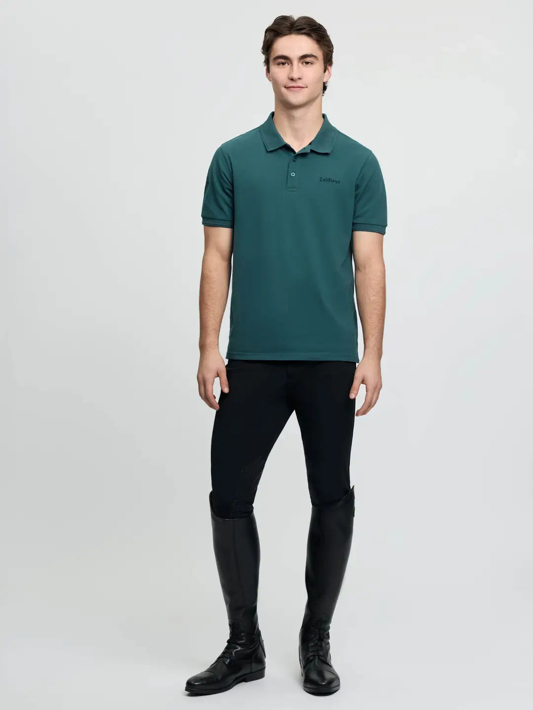 LeMieux Men’s Classique Polo Shirt in Jungle green, full body view worn with black pants