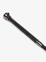 Close-up view of the handle on the black LeMieux Brilliance Schooling Whip on a white background